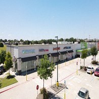 an aerial view of a building in a parking lot