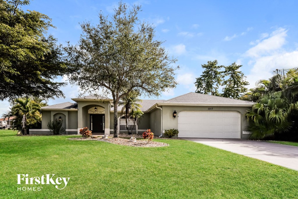 a house with a lawn and a garage