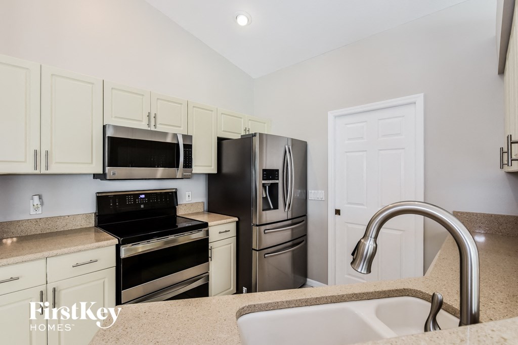 a kitchen with stainless steel appliances and a sink