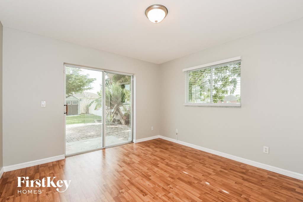 a living room with a hardwood floor and a sliding glass door