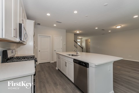 A kitchen with white cabinets and a stainless steel dishwasher.