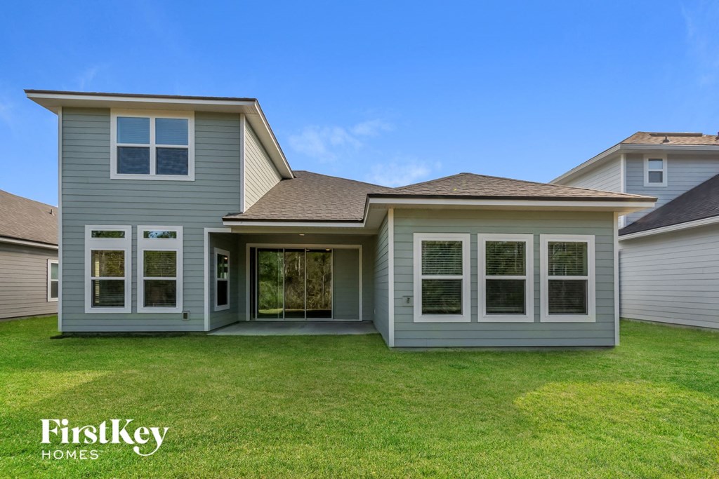 A house with a grey exterior and a brown roof is for sale by FirstKey Homes.
