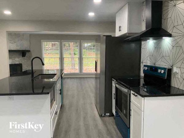 a black and white kitchen with a stove and a sink