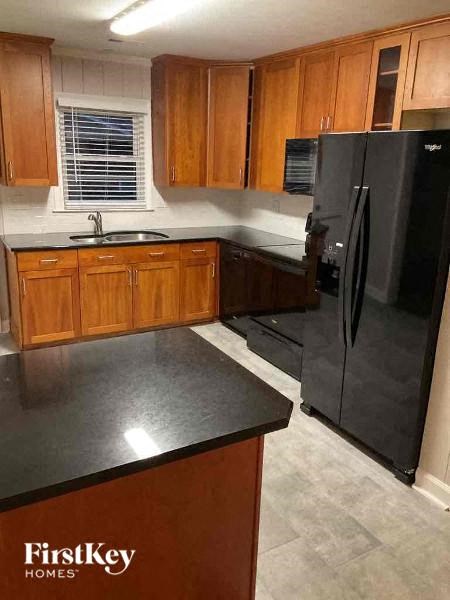 a kitchen with black appliances and wooden cabinets