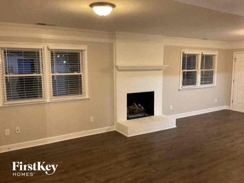 a living room with a fireplace and a wooden floor