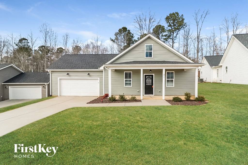 A house with a grey roof and a white garage door.
