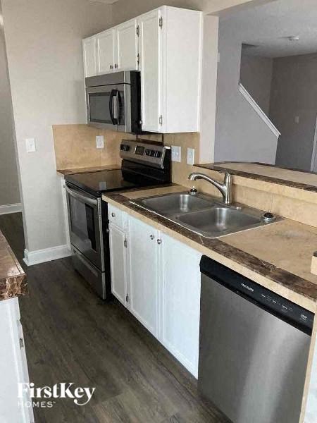 a kitchen with stainless steel appliances and white cabinets