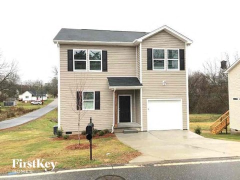 A two-story house with a garage is for sale.