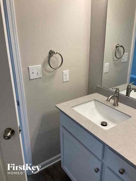 A bathroom with a sink and a mirror.