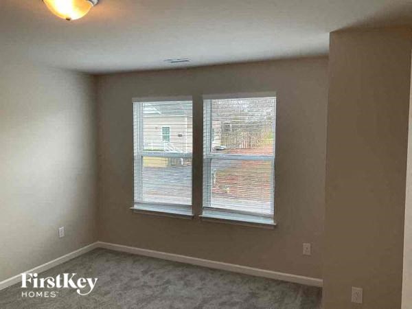 A room with a FirstKey Homes logo on the bottom left corner.