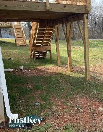 A wooden deck structure with a staircase is under construction.