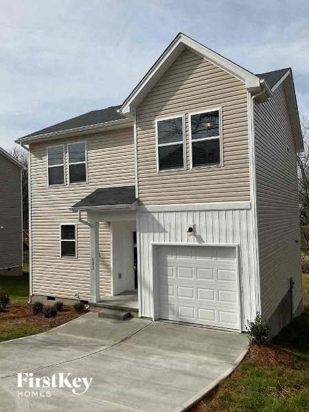 A two-story house with a garage is for sale.