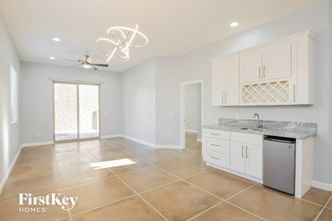 a large kitchen with white cabinets and stainless steel appliances
