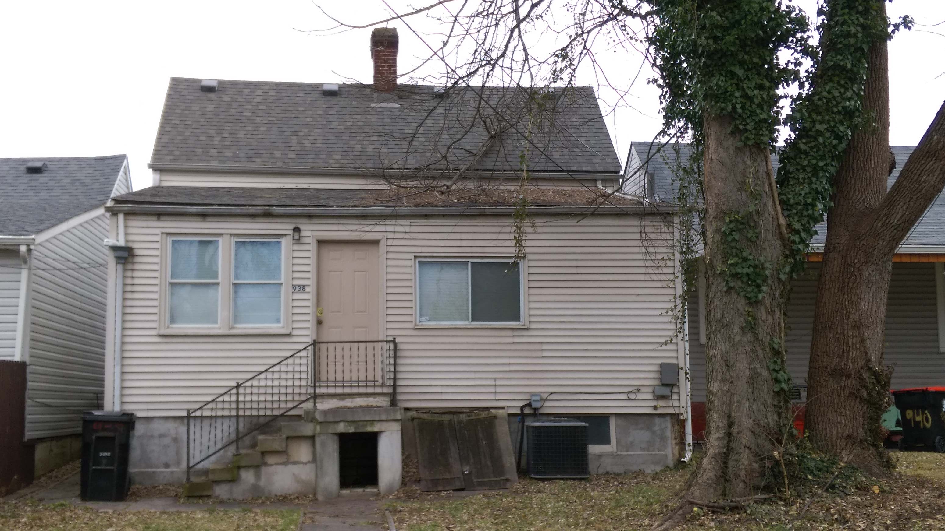 a white house with a yard and a tree