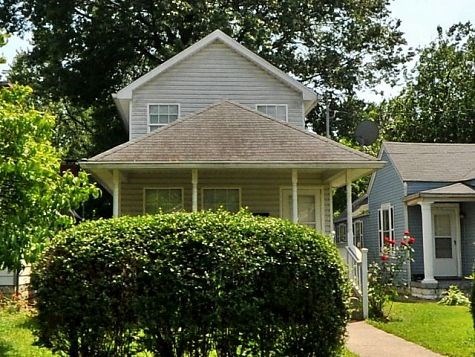 a house with a hedge in front of it