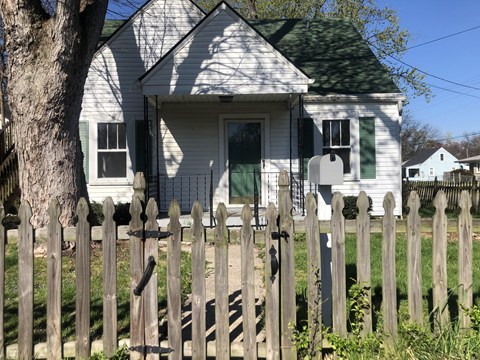 a white house with a fence in front of it