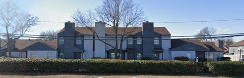a large house with a fence in front of it