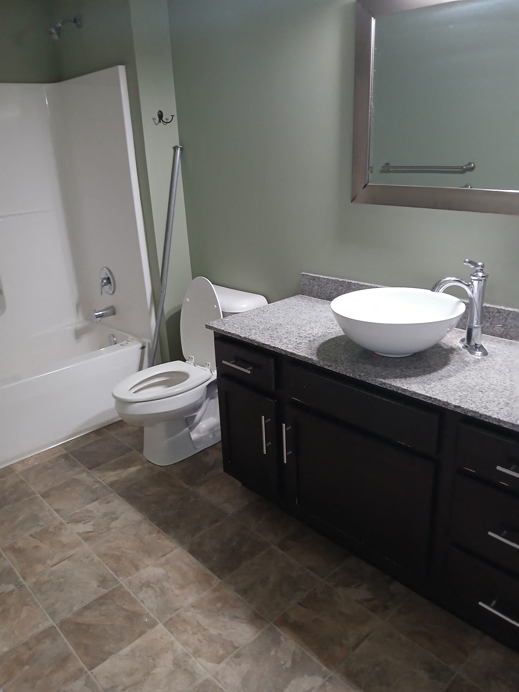 a bathroom with a sink and a toilet and a shower