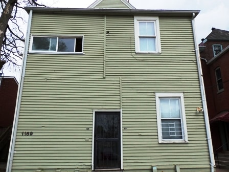 A house with a black door and white windows.