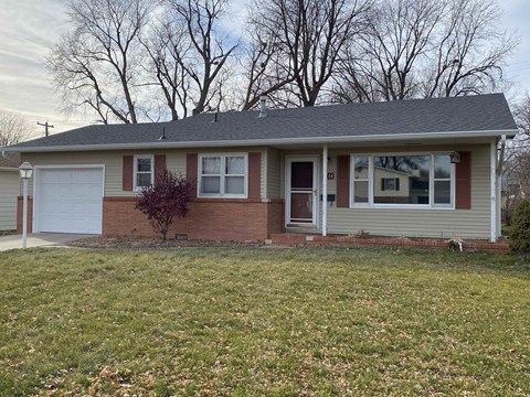 a brick house with a lawn in front of it