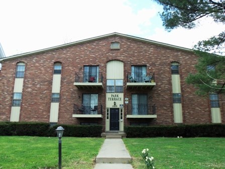 a brick building with a sidewalk in front of it