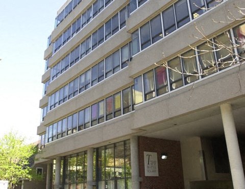 A tall building with a sign that says "Trio" on the front.