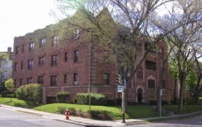 an old brick building on the corner of a street