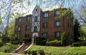 a large brick building with a staircase in front of it