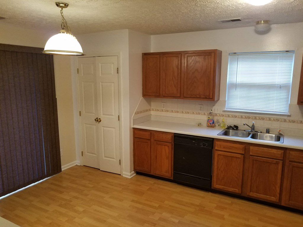 an empty kitchen with a sink and a door