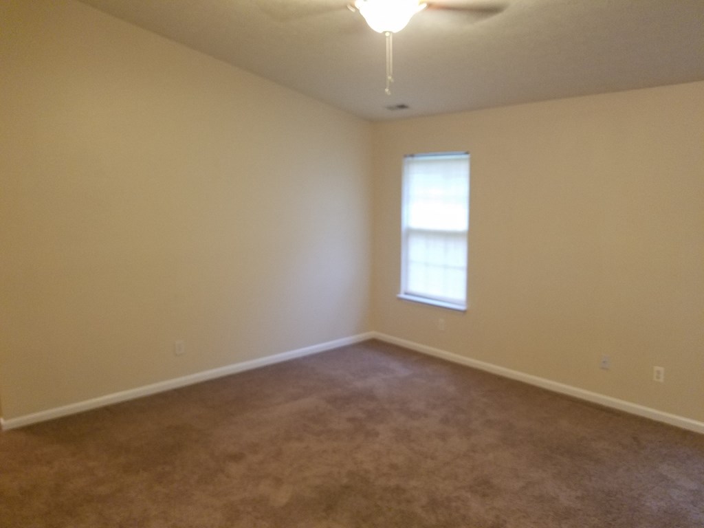an empty living room with a window