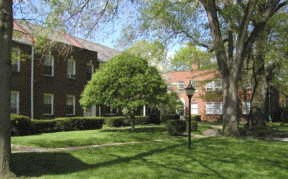 a large yard in front of a brick building
