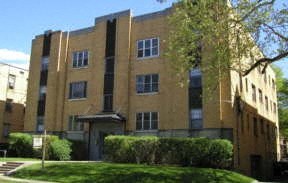 a large brick building with grass in front of it