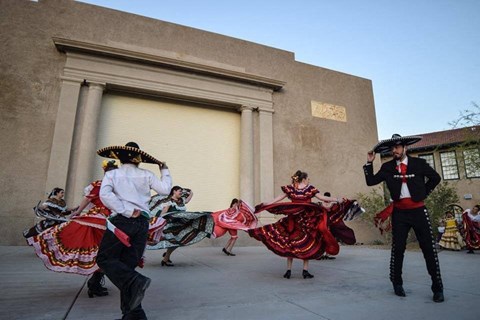 a group of people costumes dancing on the street