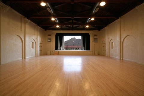 an empty room with a wooden floor and a large window