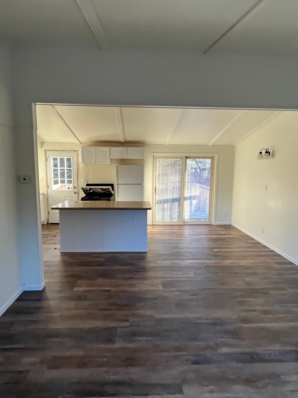 A room with wooden floors and white walls.