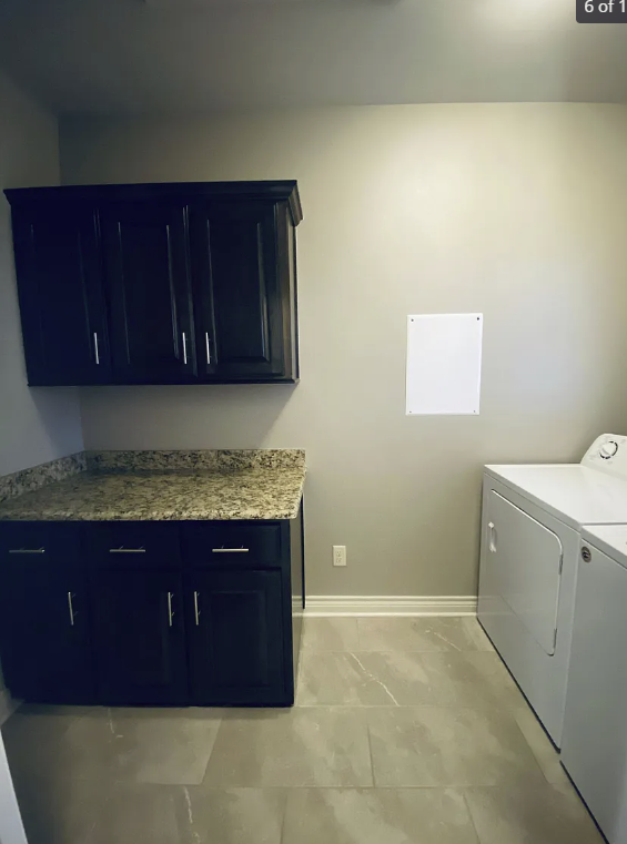 a kitchen with a washer and a dryer in it