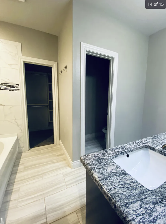 a bathroom with a sink and a door to a closet