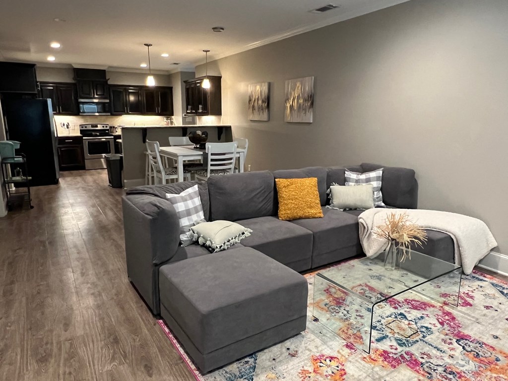 a living room and kitchen with a couch and a table