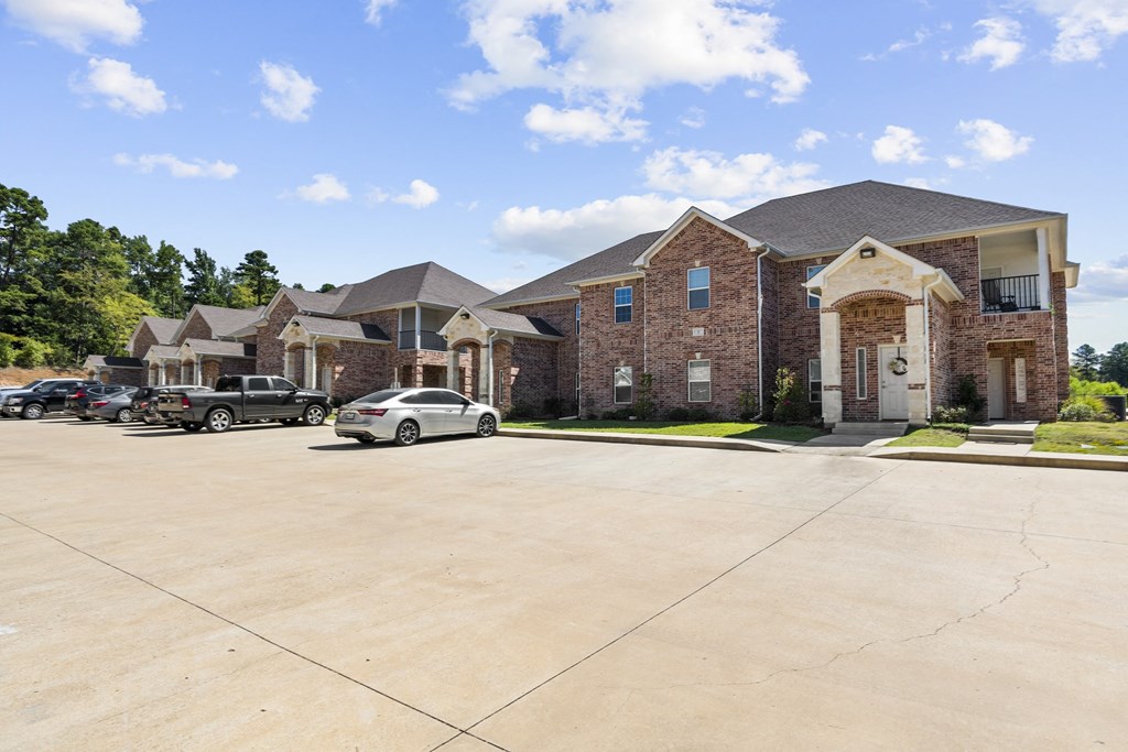 a large brick house with cars parked in front of it