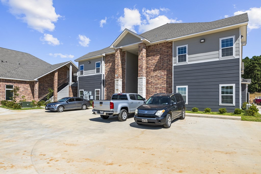 a large house with cars parked in front of it