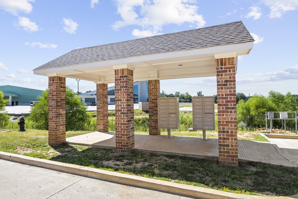 a covered parking lot with brick pillars