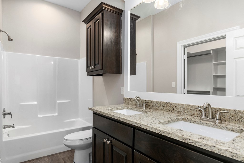 a bathroom with a sink and a toilet and a mirror