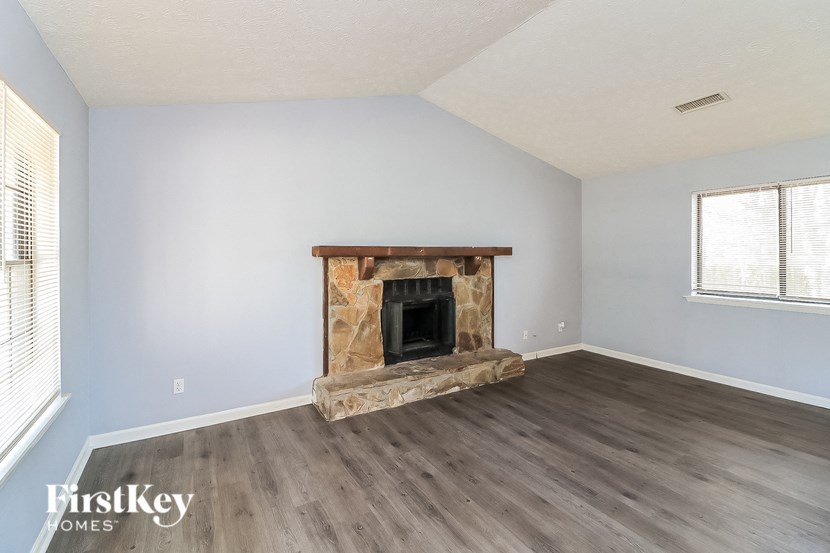 the living room of an empty house with a fireplace