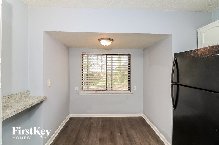 a small kitchen with a refrigerator and a window