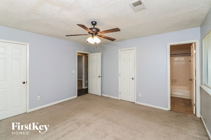 a living room with blue walls and a ceiling fan