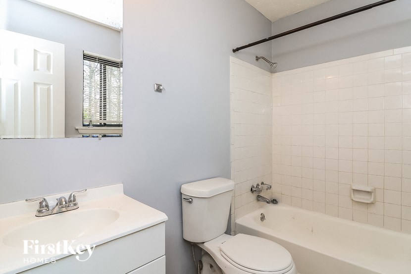 a bathroom with a sink toilet and a bath tub