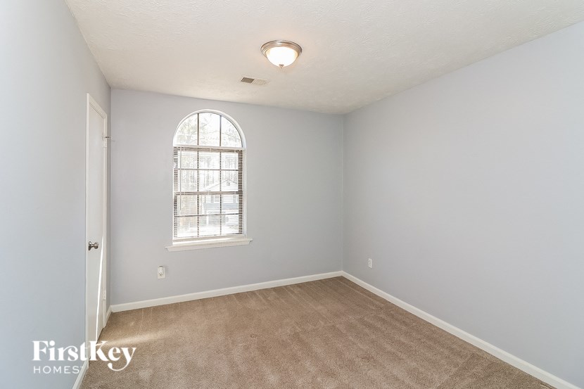 a bedroom with blue walls and a window