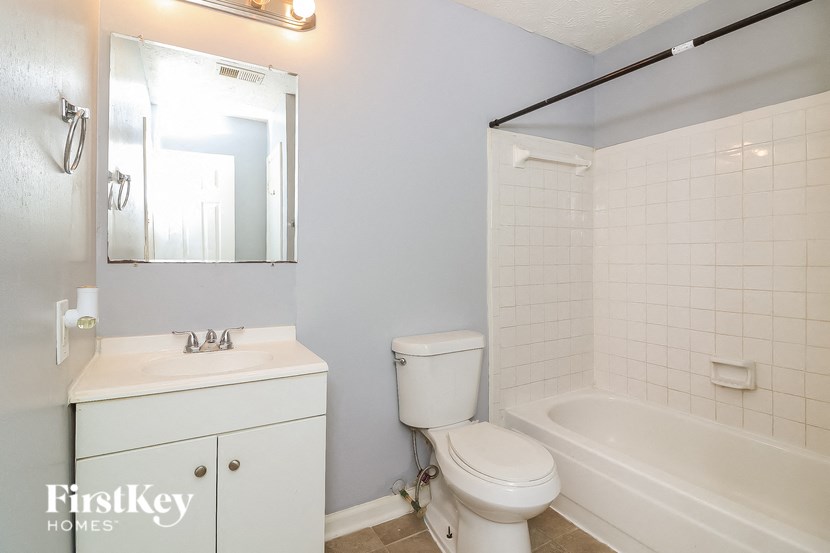 a bathroom with a sink toilet and a bath tub