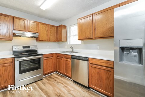 A kitchen with wooden cabinets and stainless steel appliances.