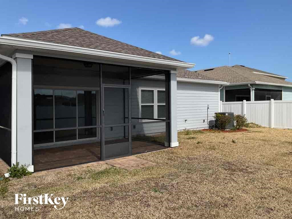 a covered patio in front of a house
